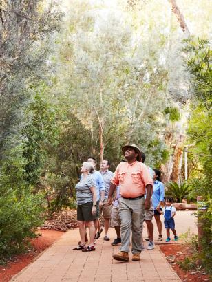 Group taking guided tour of gardens at Ayers Rock Resort