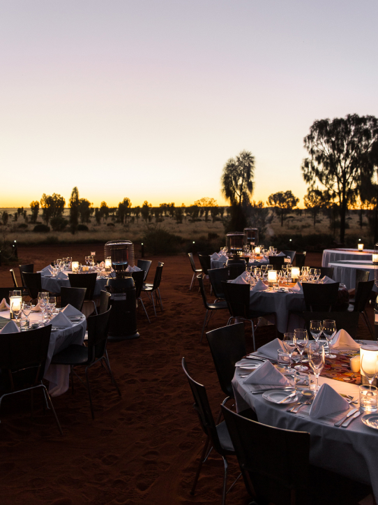 Dining tables set up outdoors at dusk