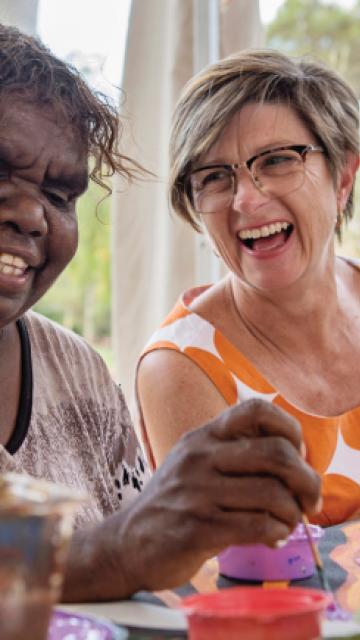 People painting indigenous art with their hands  | Voyages Indigenous Tourism 