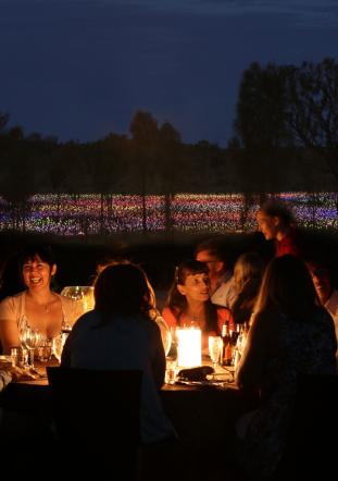 Dinner by candlelight in front of Field of Light at Ayers Rock