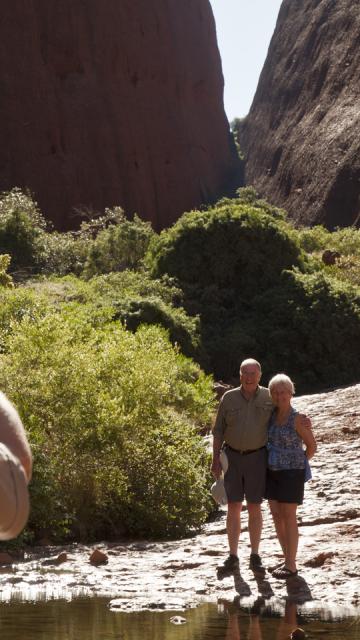 Visitors standing in front of rocks having their photo taken