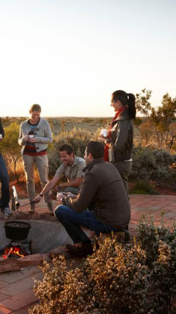 people sitting around a firepit