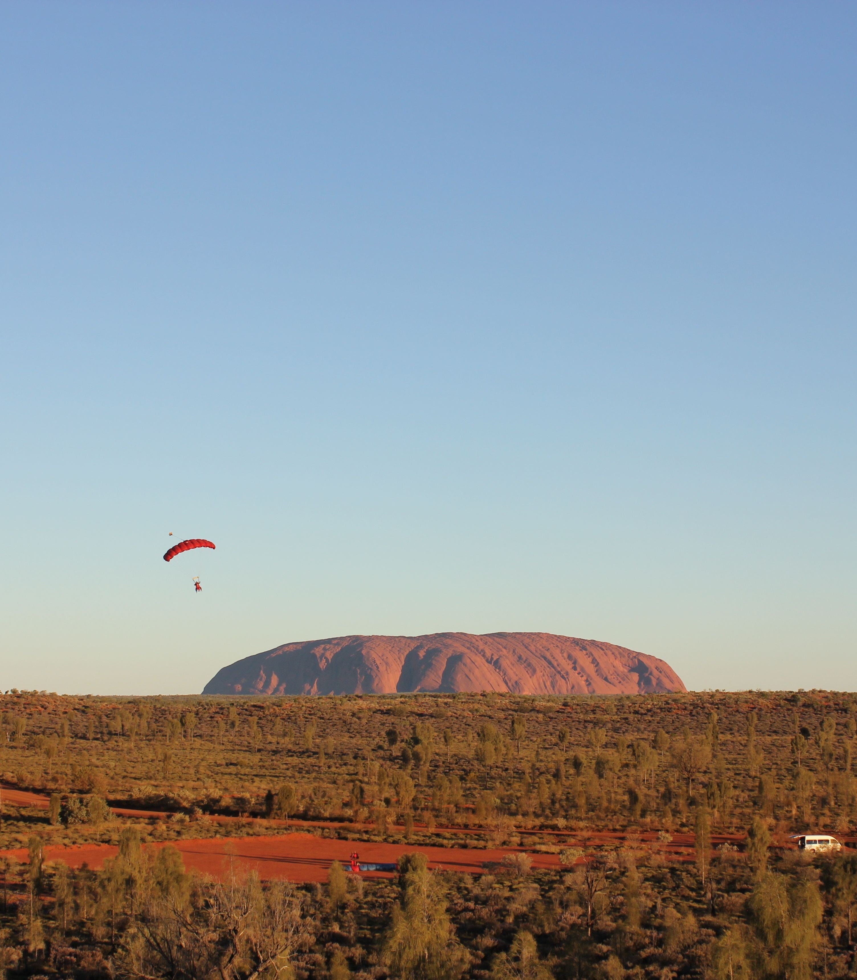 Parachute in the air front of Uluru